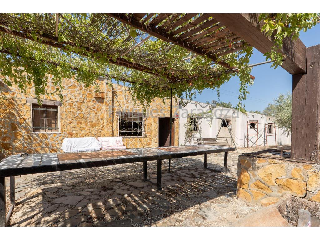 Rustic property for sale located in Santa Bárbara, in the Mangrané area, with an approximate surface area of 5,534 m², planted with olive trees and currently not in production.Within the property there is a country house, the original construction of which dates back to 1980, with an initial surface area of approximately 25 m². Since its construction, several extensions have been carried out, bringing the total built area to approximately 260 m², distributed between living accommodation, storage areas and other outbuildings.The residential area is fully finished and comprises one bedroom, a complete bathroom with all sanitary fittings installed, a finished kitchen equipped with a gas cooker and fireplace, tiled flooring, windows and a storage room.Adjacent to the living area there is a storage space, as well as another sizeable extension where construction began on a large living room with several adjoining rooms. This part of the building was left unfinished, offering the possibility of completing and adapting the spaces according to the needs and project of the future owner.Outside the house, there is a porch built with wooden beams, providing a pleasant partially covered area next to the house, as well as a barbecue area.The property has its own rainwater collection and storage system. Rainwater is collected in a cistern and subsequently transferred to different tanks for storage and use.Regarding the electricity supply, the property is not connected to the mains electricity network and operates using a diesel-powered generator.Overall, this is a rustic property of approximately 5,534 m², planted with olive trees and with approximately 260 m² of built area, combining fully finished areas with other spaces that remain to be completed, offering various possibilities for use and adaptation.A property particularly suited to those looking for space, tranquillity and a rural setting, with a substantial building and its own land in the Santa Bárbara area.The stated price does not include expenses and taxes arising from the transfer of ownership, such as notarial, land registry and administrative fees, as well as any applicable taxes (Property Transfer Tax, Value Added Tax or Stamp Duty), all of which shall be borne entirely by the purchaser, in accordance with current legislation.Real estate agency fees are included in the agreed sale price.For information and consultation regarding the applicable tax regime, it is recommended to visit the website of the Catalan Tax Agency: Agència Tributària de CatalunyaThe information contained in this advertisement is provided for informational and guidance purposes only and does not constitute, under any circumstances, a binding offer or contract. Finques Zaragoza Immobiliaria Delta de l’Ebre, SL. reserves the right to modify, update or correct the content of this advertisement at any time without prior notice.